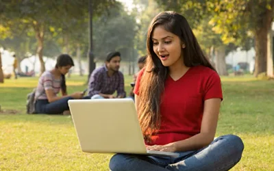 Girl in red shirt using laptop