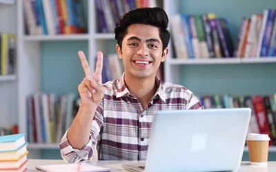 Happy boy studying online