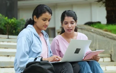 Two friends with laptop